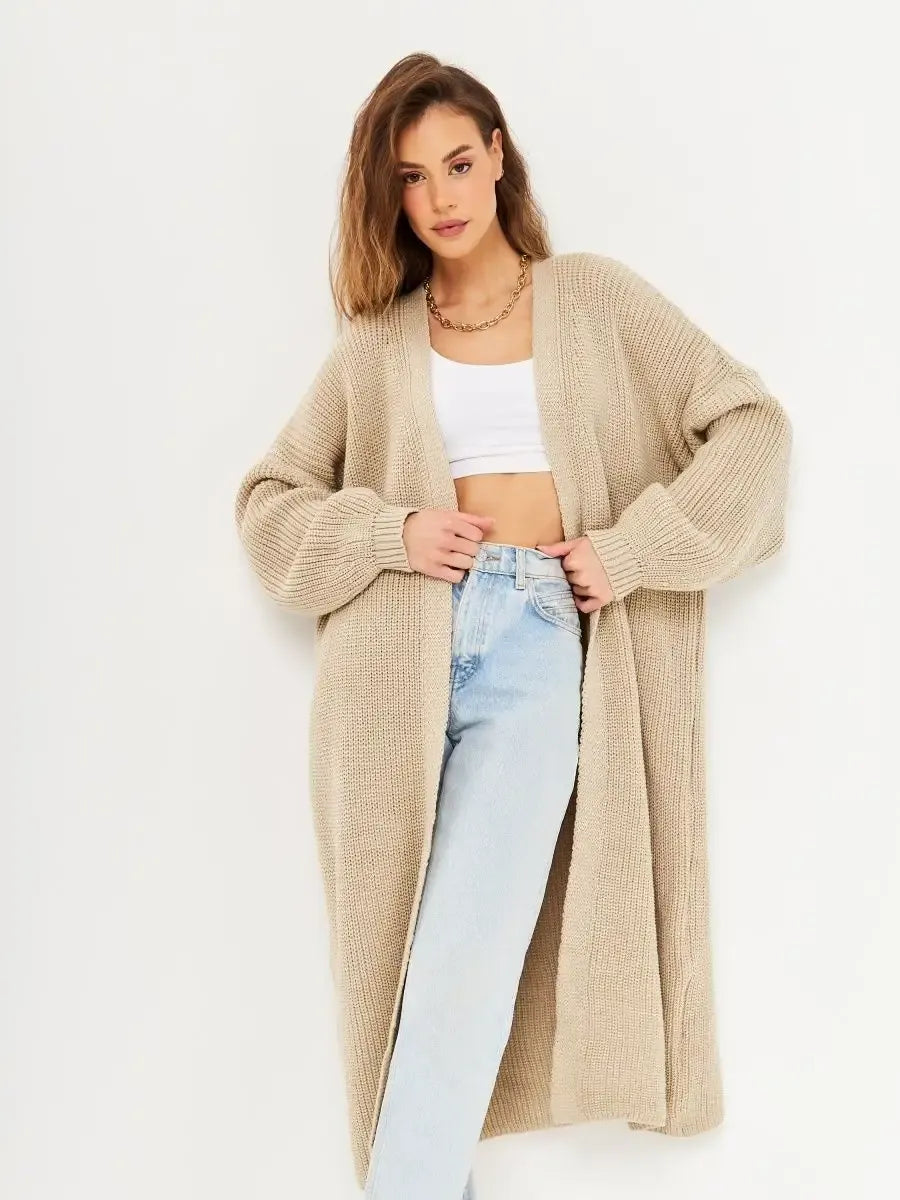 Sable Cardigan by Lauven worn by a model, showcasing its long oversized knitwear design in a beige color.