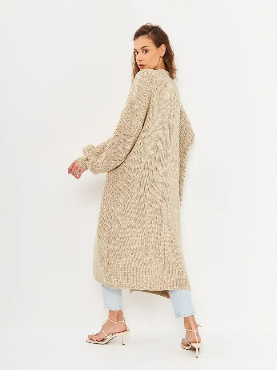 Woman wearing Sable Cardigan by Lauven, showcasing the long oversized knitwear coat from the back.