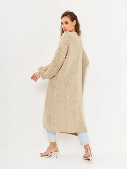 Woman wearing Sable Cardigan by Lauven, showcasing the long oversized knitwear coat from the back.