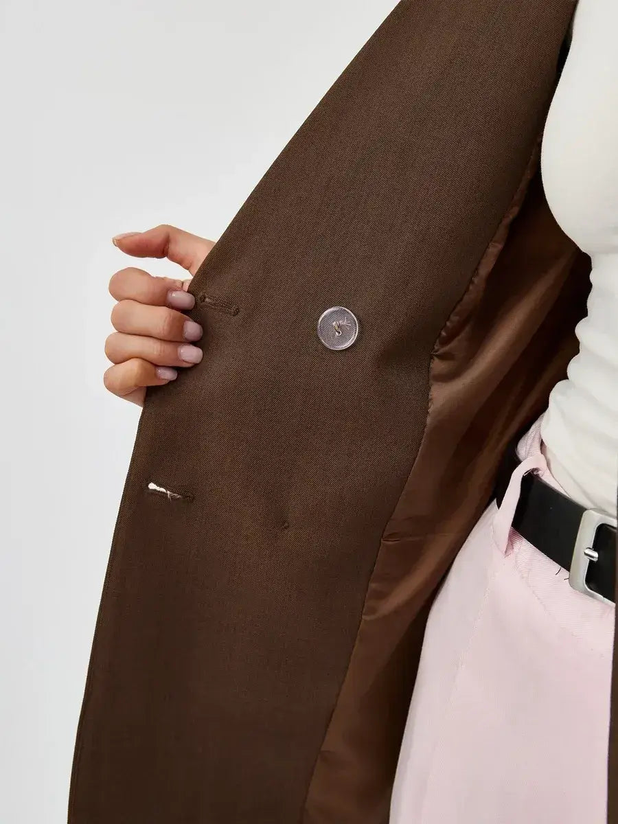 Close-up of the interior of the Saffron Blazer by Lauven, showcasing its chocolate fabric and double-breasted detail.