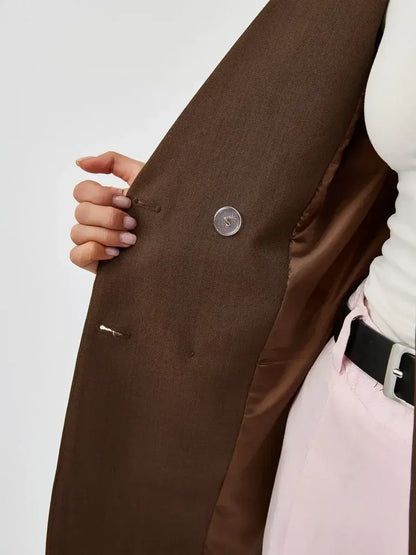 Close-up of the interior of the Saffron Blazer by Lauven, showcasing its chocolate fabric and double-breasted detail.