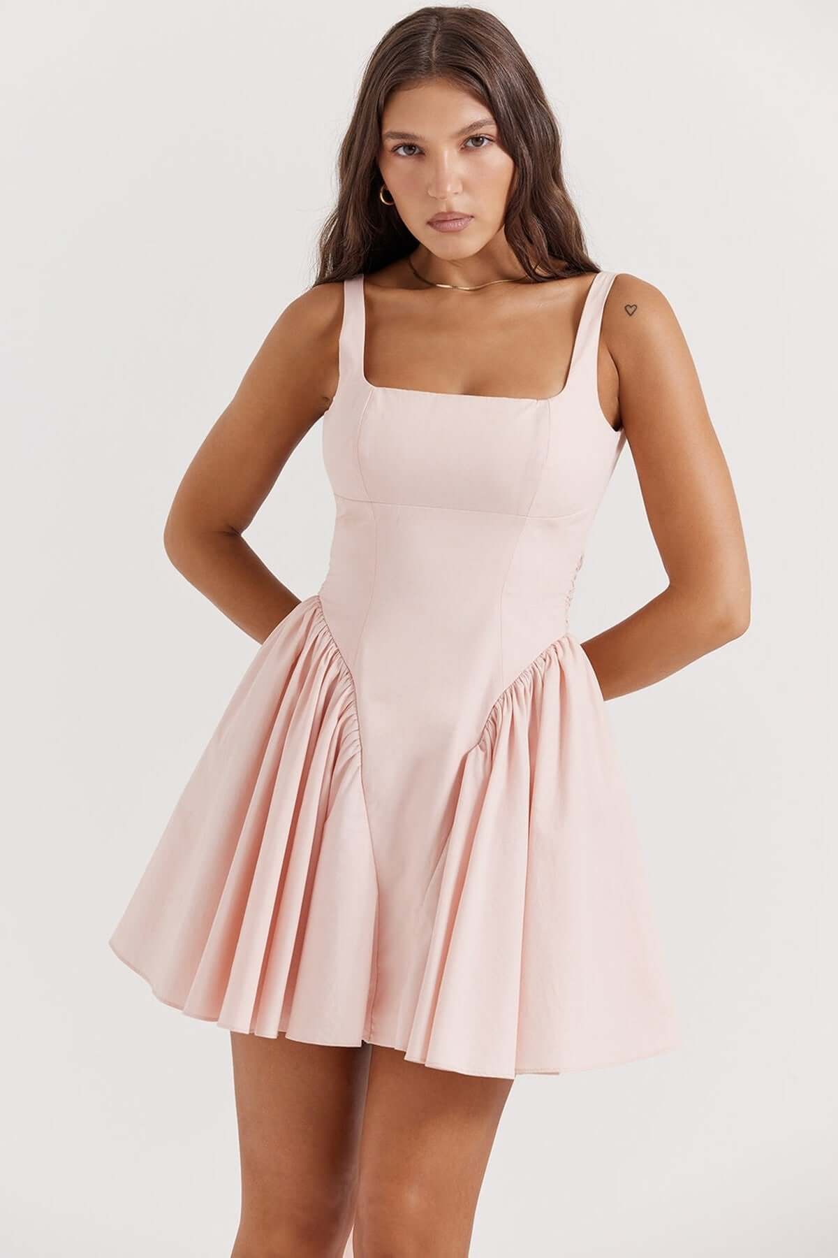 Sage Mini Dress in soft pink with a fitted bodice and flared skirt, ideal for summer occasions and stylish events.