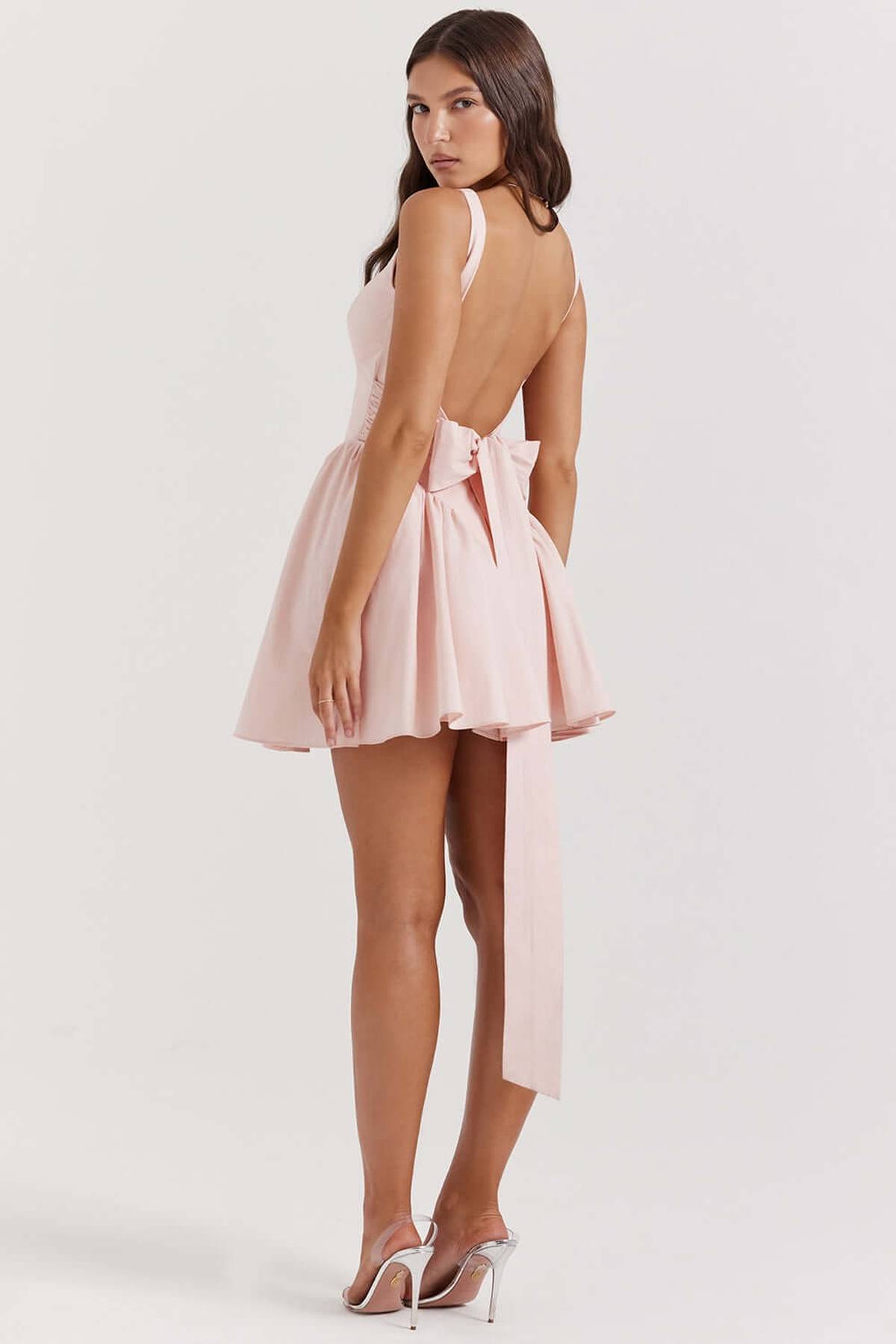 Stylish pink Sage Mini Dress with bow detail and open back, perfect as a summer dress or for wedding guests.