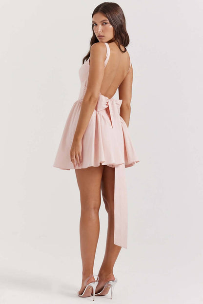 Stylish pink Sage Mini Dress with bow detail and open back, perfect as a summer dress or for wedding guests.