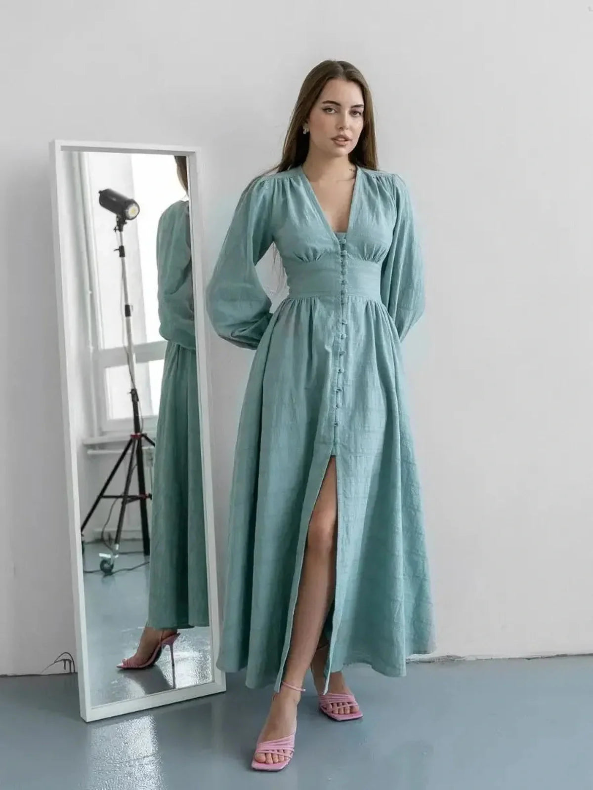 Model wearing the Sage Muse Maxi Dress in soft sage green, featuring a full-length silhouette and elegant fabric buttons.