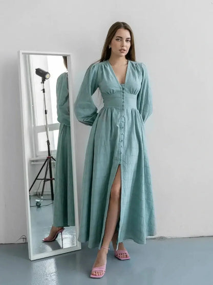 Model wearing the Sage Muse Maxi Dress in soft sage green, featuring a full-length silhouette and elegant fabric buttons.