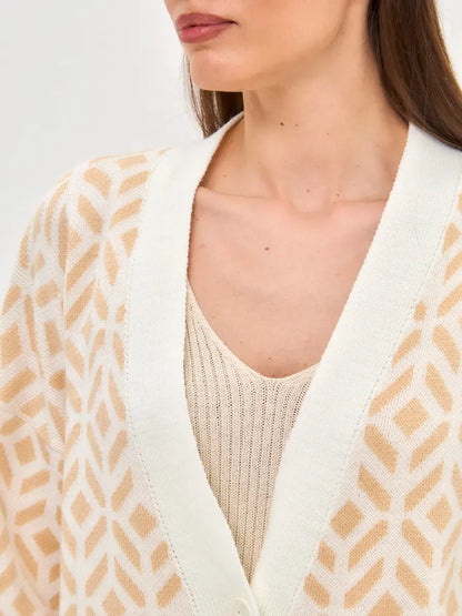 Sandy Cardigan by Lauven featuring a close-up view of its soft beige knit design and relaxed silhouette.