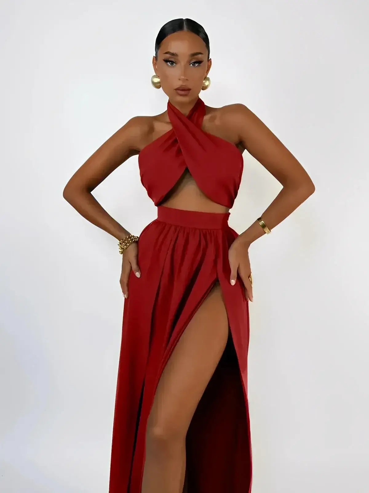 Model showcasing the Scarlet Mirage Set by Lauven, featuring a draped halter top and slit skirt in vibrant crimson.