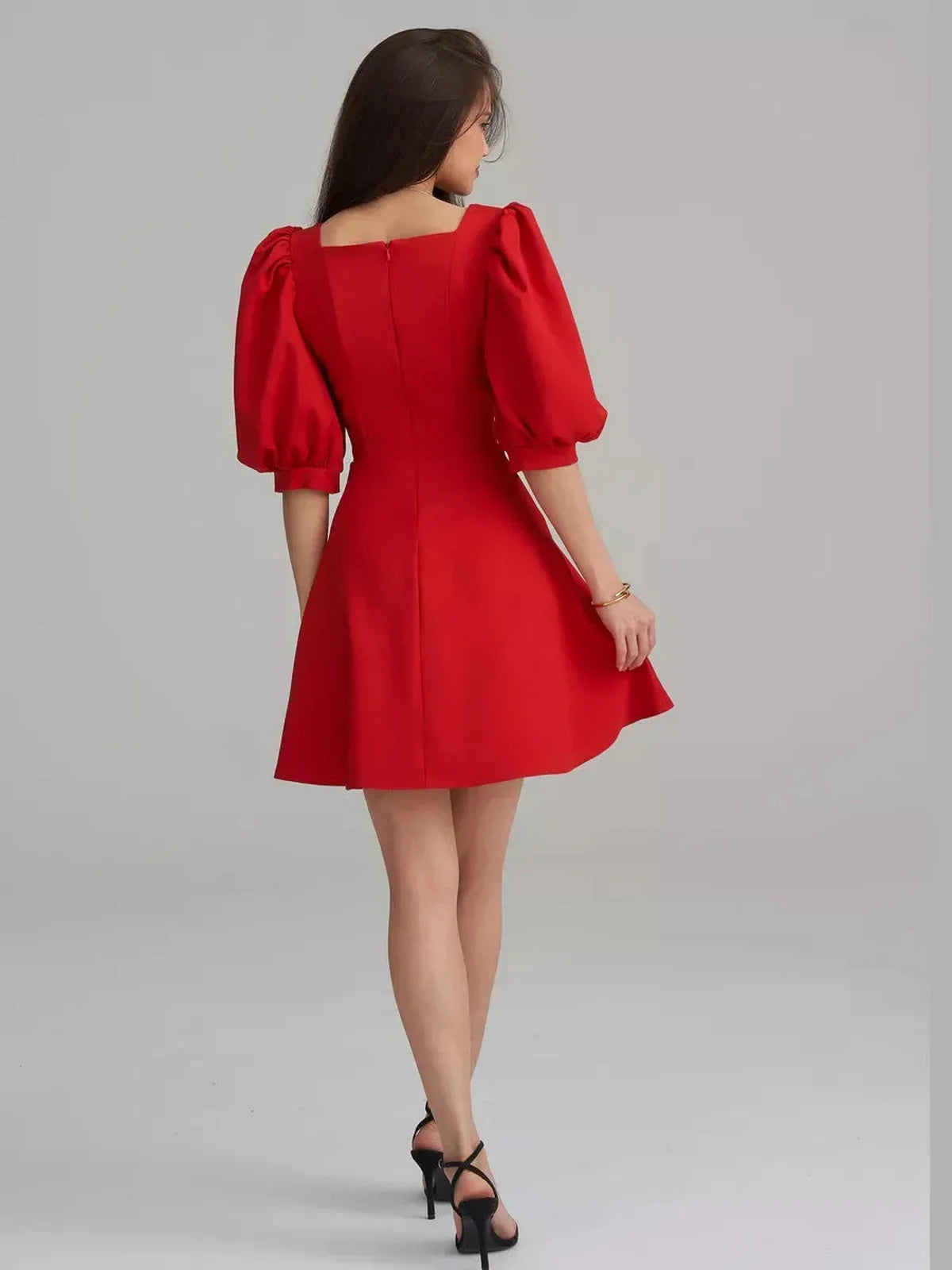 Scarlet Muse Red Mini Dress showcasing puff sleeves and flared skirt from the back, perfect for elegant occasions.
