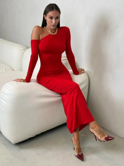 Model wearing a sleek one-shoulder scarlet maxi dress, showcasing elegant draping and a bold red hue.