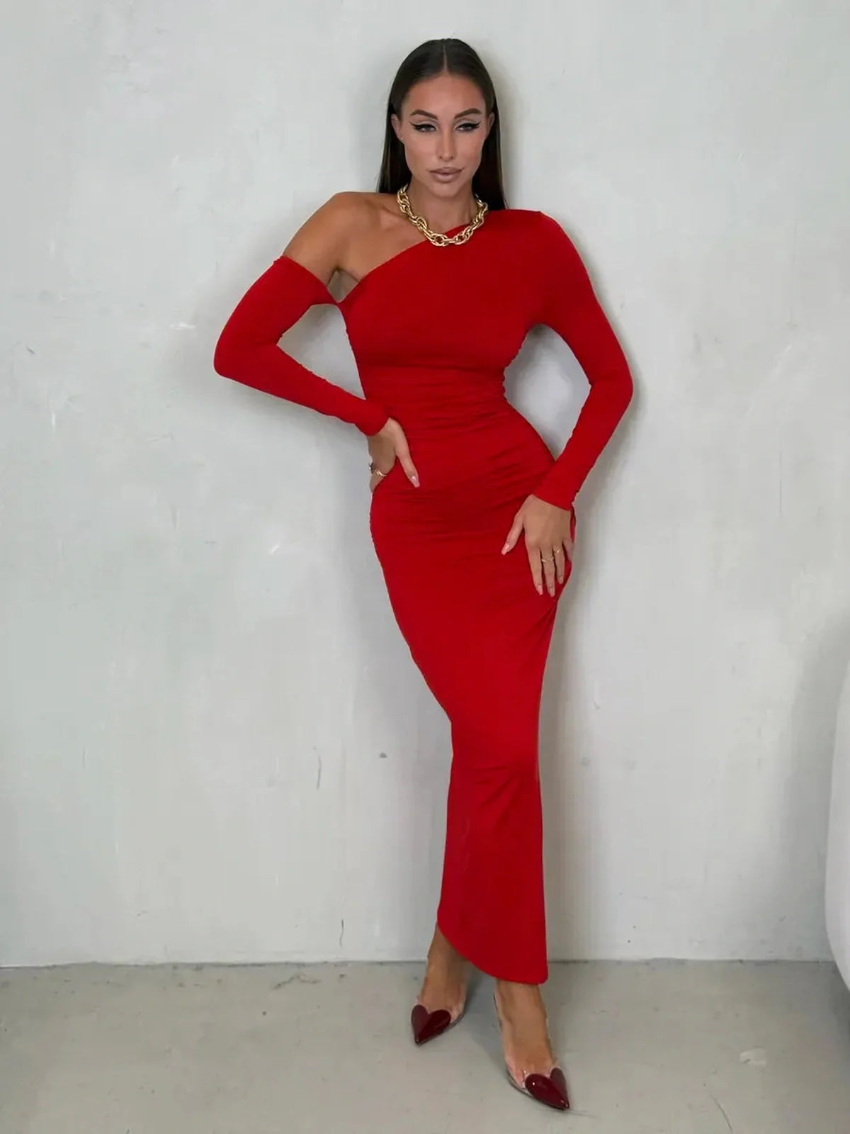 Model showcasing the Scarlet Sculpt Maxi Dress in red, featuring a one-shoulder design and elegant silhouette.
