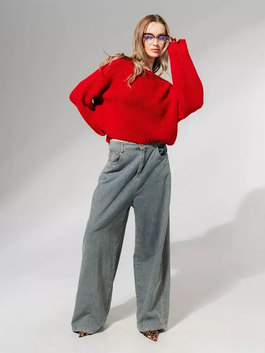 Model wearing a Scarlet Sweater by Lauven in deep red with oversized fit and stylish gray wide-leg pants.