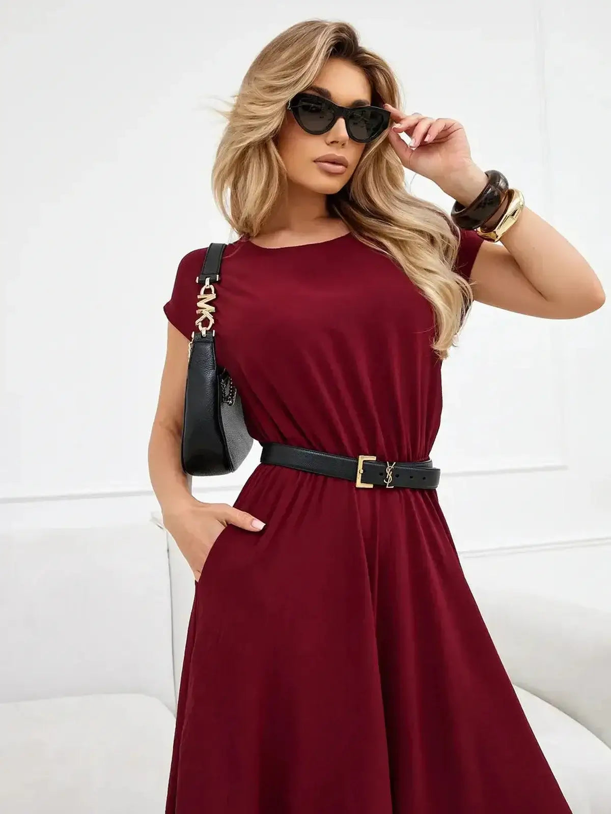 Sculpted Ease Maxi Dress in deep burgundy, featuring a cinched waist, flowing skirt, and stylish accessories.