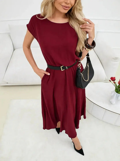 Woman wearing a burgundy Sculpted Ease Maxi Dress with a cinched waist, styled for casual elegance.