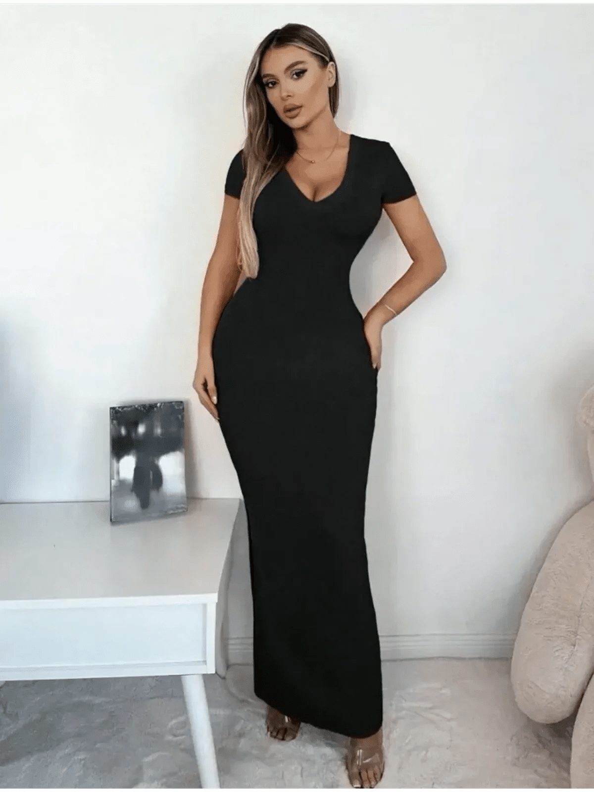 Model wearing a Sculpted Elegance Maxi Dress featuring a flattering V-neckline and sleek fit, showcasing minimalist glamour.