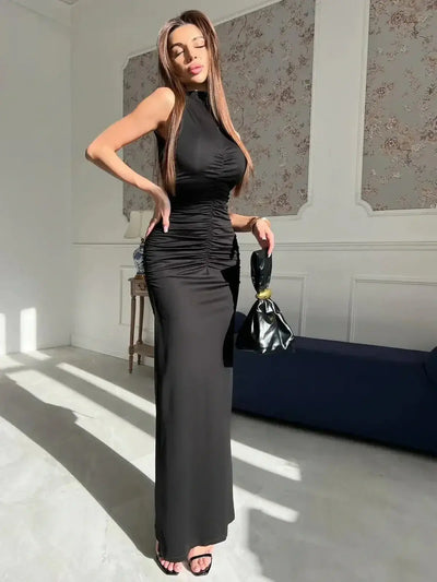 Sculpted Grace Maxi Dress showcasing elegant draping and a sleek silhouette in deep black with satin sheen.