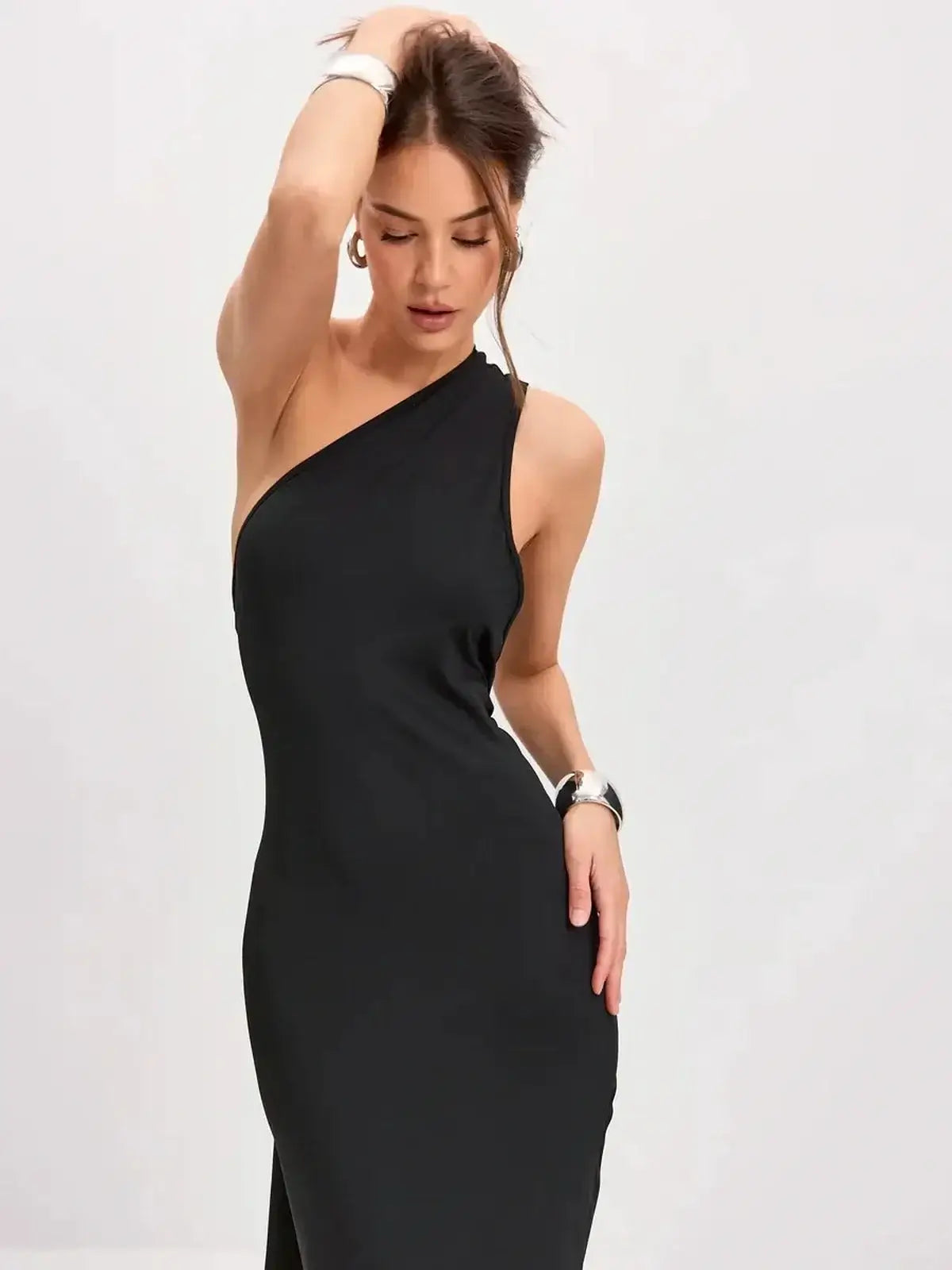 Model wearing a black Sculpted Grace Maxi Dress with a one-shoulder design and sleek silhouette.