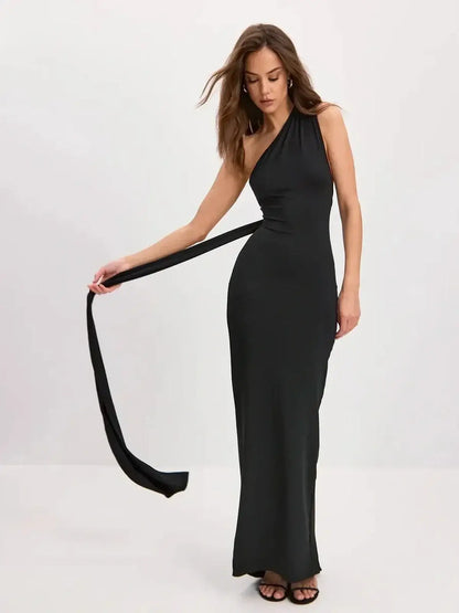 Sculpted Grace Maxi Dress, one-shoulder black silhouette with sweeping scarf-tie for an elegant look.