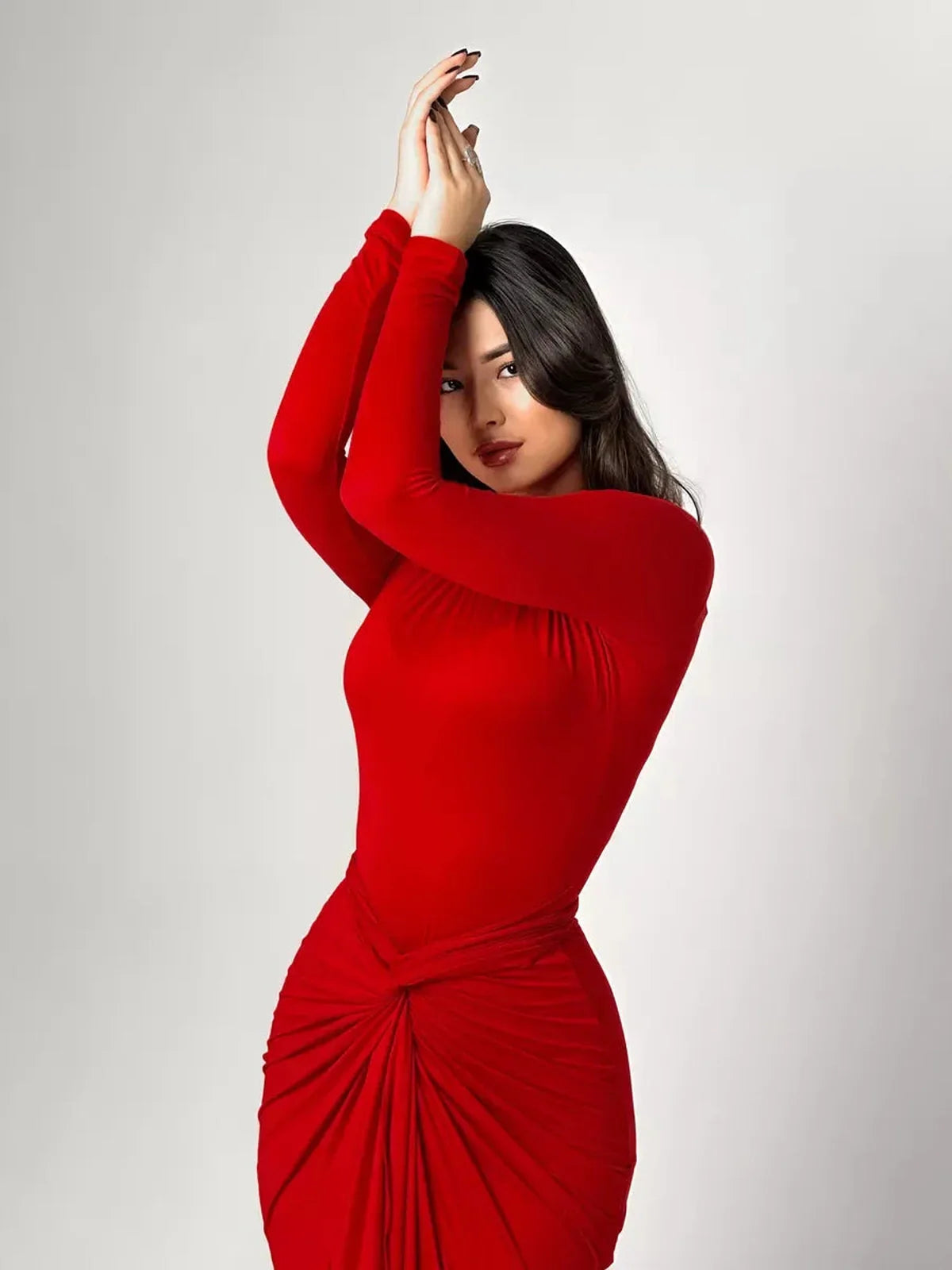 Model showcasing the Sculpted Grace Maxi Dress in red, featuring a sleek silhouette and stylish knotted waist detail.