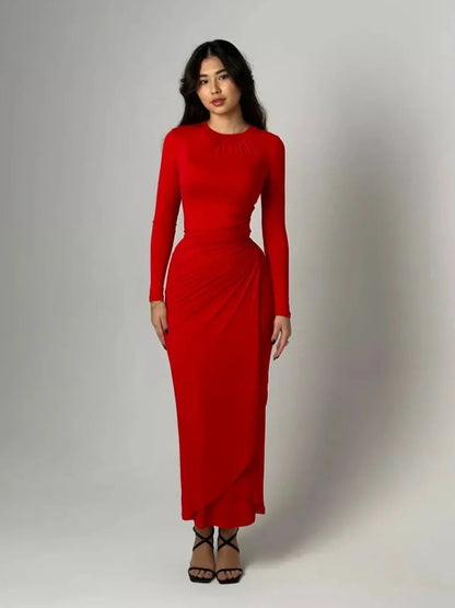 Model wearing the Sculpted Grace Maxi Dress in red, featuring luxe draping and a flattering silhouette.