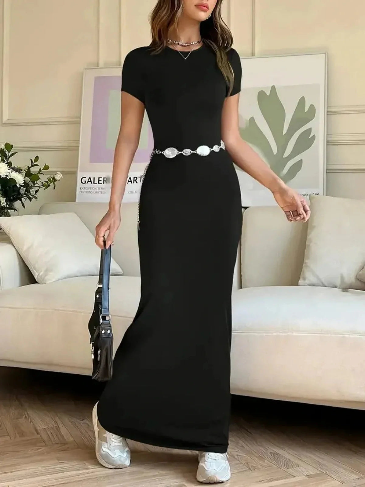 Sculpted Grace Maxi Dress in black, showcasing a sleek silhouette and elegant details for a modern look.