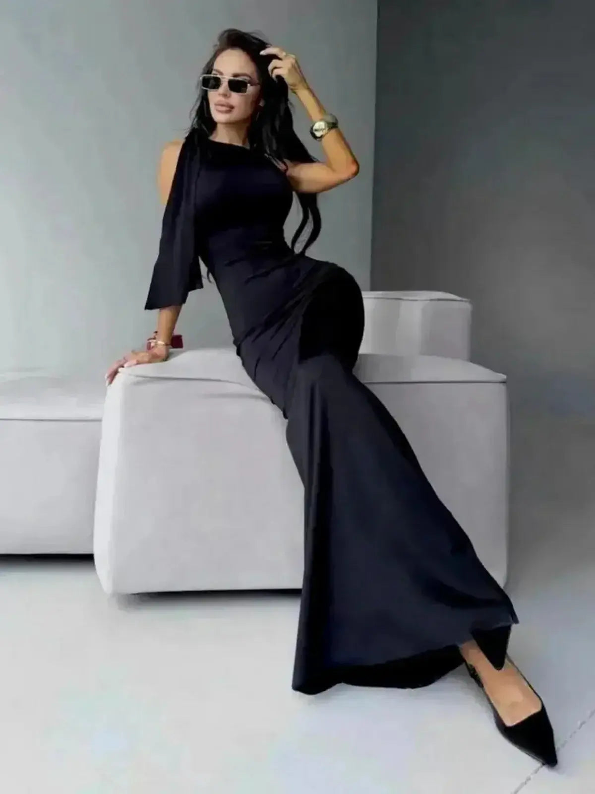 Sculpted Noir Maxi Dress showcasing sleek silhouette and elegant bow detail, perfect for modern elegance and refined style.