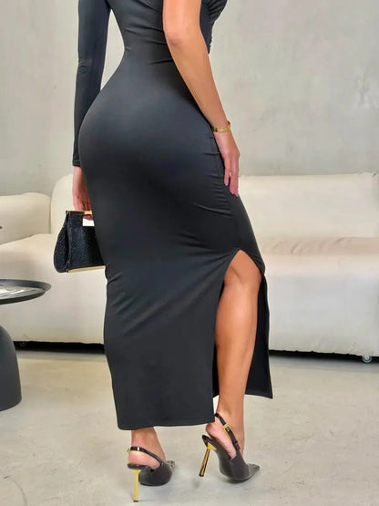 Model showcasing the Sculpted Noir Maxi Dress, emphasizing the side slit and ruched silhouette for evening elegance.