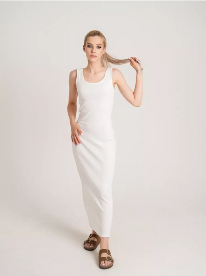 Model showcasing the Sculptura Maxi Dress in white, highlighting its sleek ribbed elegance and comfortable fit.