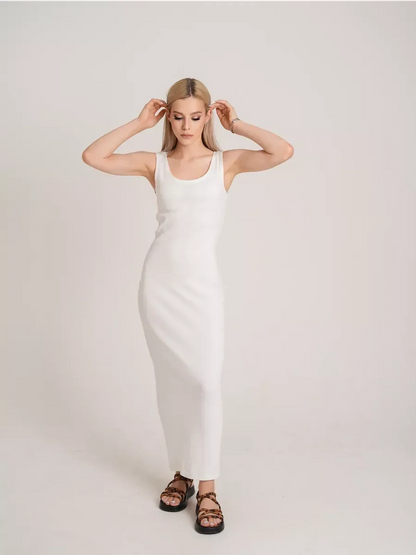 Model wearing the Sculptura Maxi Dress featuring a sleek white ribbed design, perfect for warm weather.