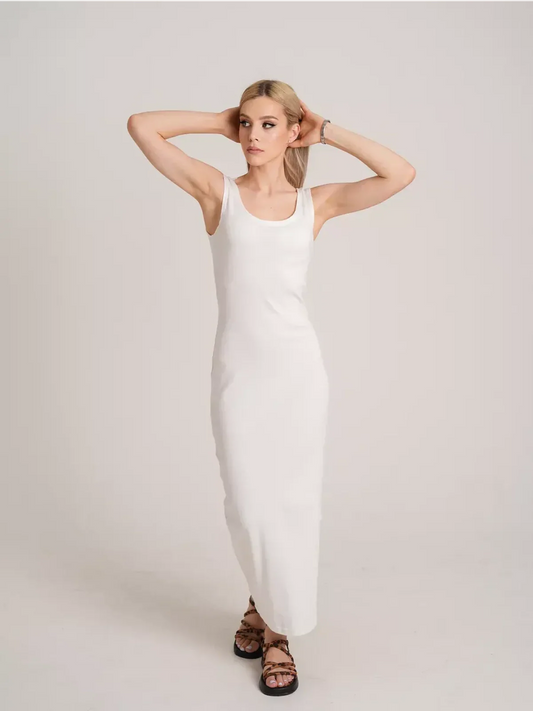 Model showcasing the Sculptura Maxi Dress in white, embodying sleek ribbed elegance and contemporary minimalism.