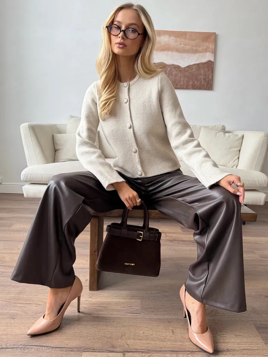 Selene Cardigan by Lauven: Chic beige cropped knitwear with decorative buttons, elegantly paired with trendy pants.