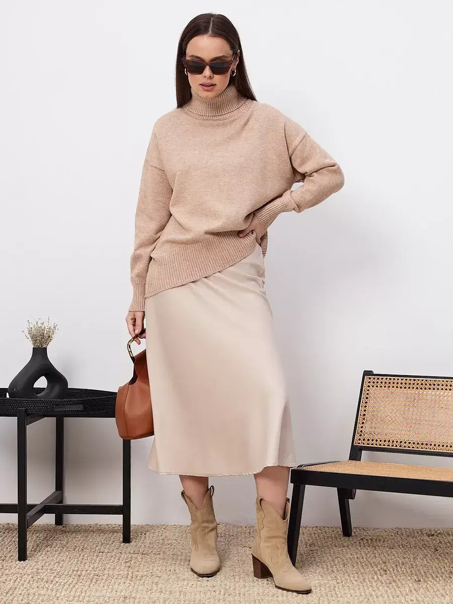 Selene Sweater by Lauven in dark beige, styled with a silk skirt and boots, perfect for modern fashion.