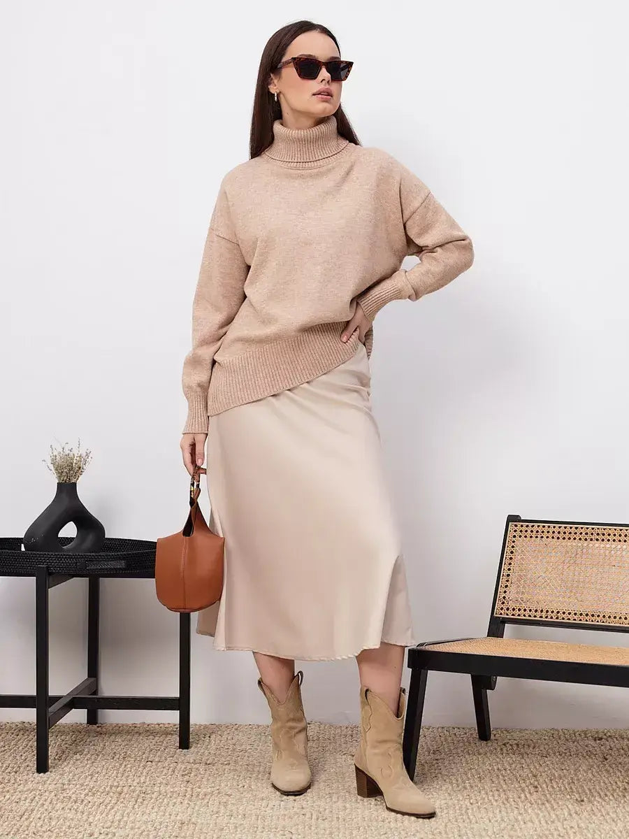 Selene Sweater by Lauven in dark beige, styled with a beige skirt and sunglasses, showcasing modern comfort and timeless elegance.