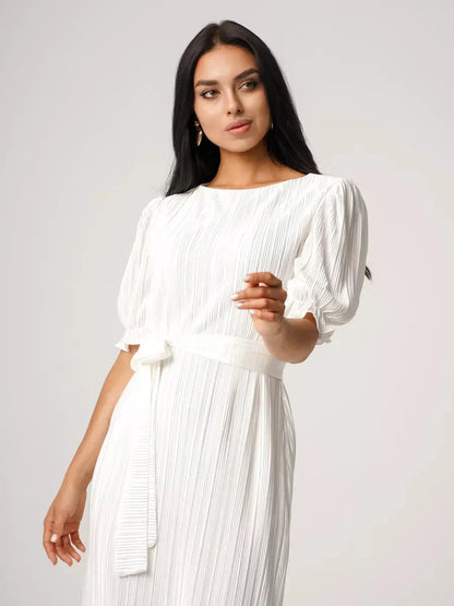 Model showcasing the Seraphine Maxi Dress, featuring pleated elegance and a refined silhouette in white.