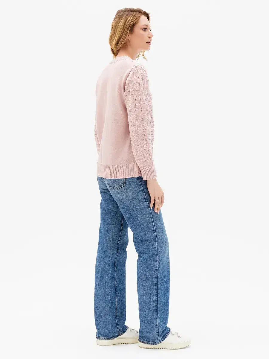 Seren Sweater in powder pink by Lauven, showcasing a stylish design with cable knit sleeves.