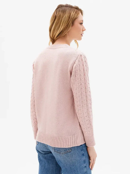 Seren Sweater by Lauven in powder pink, showcasing cable knit sleeves and textured front, perfect for stylish comfort.