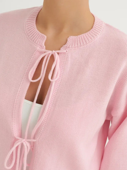 Serena Cardigan by Lauven in soft powder pink, featuring delicate ties and lightweight summer knitwear design.