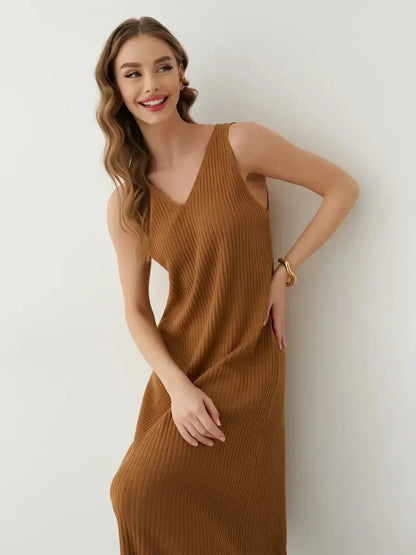Smiling woman wearing a sleeveless ribbed Serena Maxi Dress in a warm brown shade, showcasing effortless elegance.