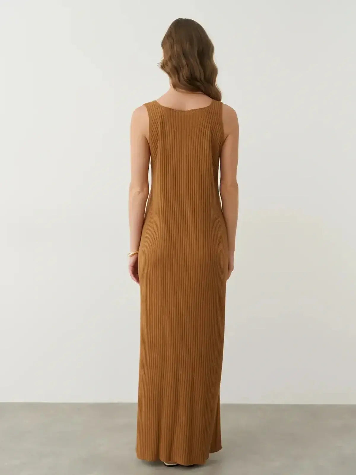 Back view of the Serena Maxi Dress featuring a sleeveless ribbed design in warm brown, perfect for elegant and casual styling.