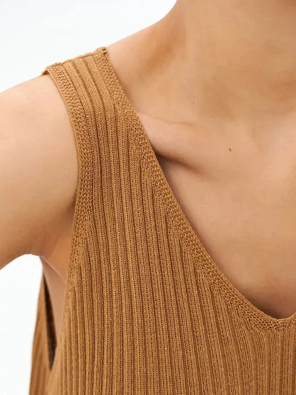 Close-up of the ribbed fabric and V-neckline of the Serena Maxi Dress in a warm brown color.