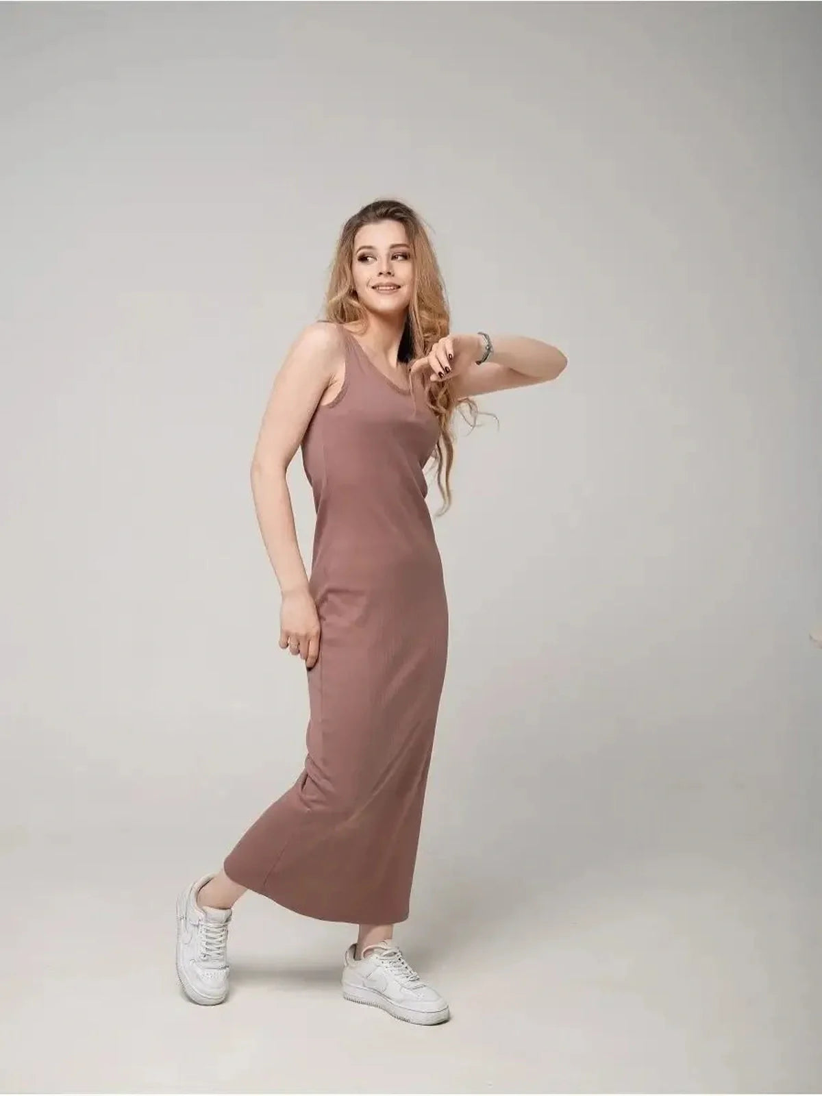 Model wearing Serene Flow Maxi Dress in a warm hue, showcasing relaxed elegance and comfort with stylish sneakers.