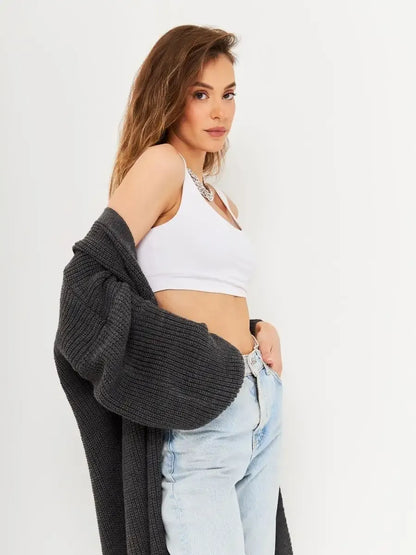 Model showcasing the Shadow Cardigan by Lauven, a long oversized knitwear coat in deep gray.