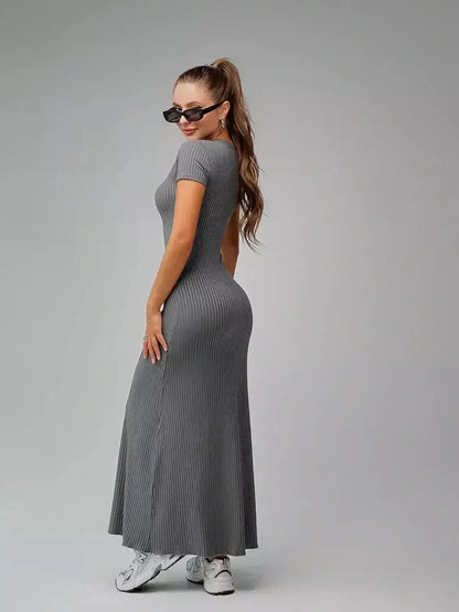 Model wearing a form-fitting gray Shadow Curve Maxi Dress, showcasing a sleek silhouette and modern minimalism.
