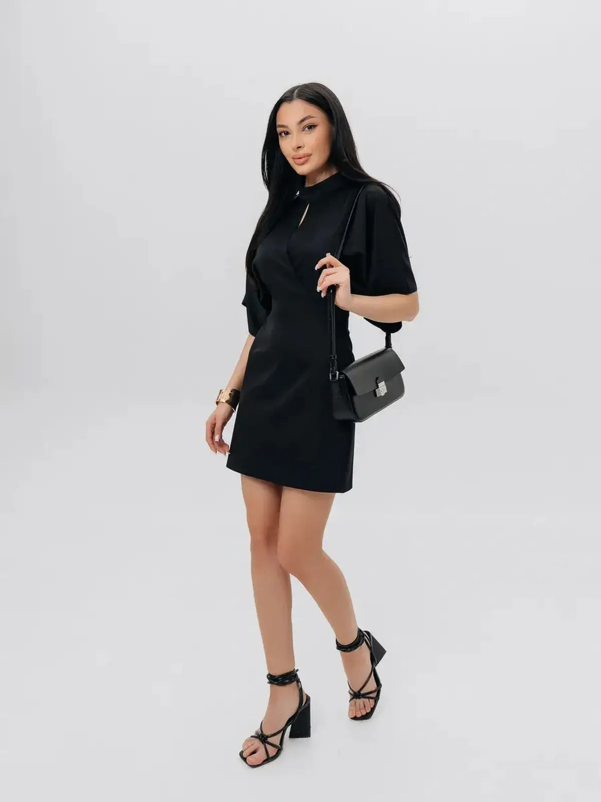 Model wearing the elegant Shadow Grace black mini dress, perfect for cocktail parties and summer events.