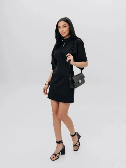 Model wearing the elegant Shadow Grace black mini dress, perfect for cocktail parties and summer events.