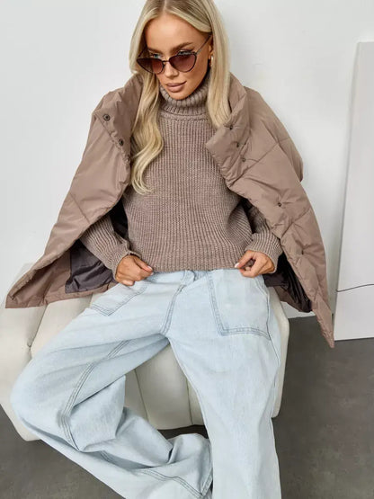 Siena Sweater by Lauven, oversized beige knit with a turtleneck, styled with a tan jacket and denim.