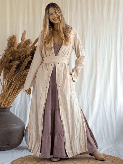 Model wearing Sienna Breeze Maxi Dress, a tiered linen summer dress with a self-tie belt and rich mocha hue.
