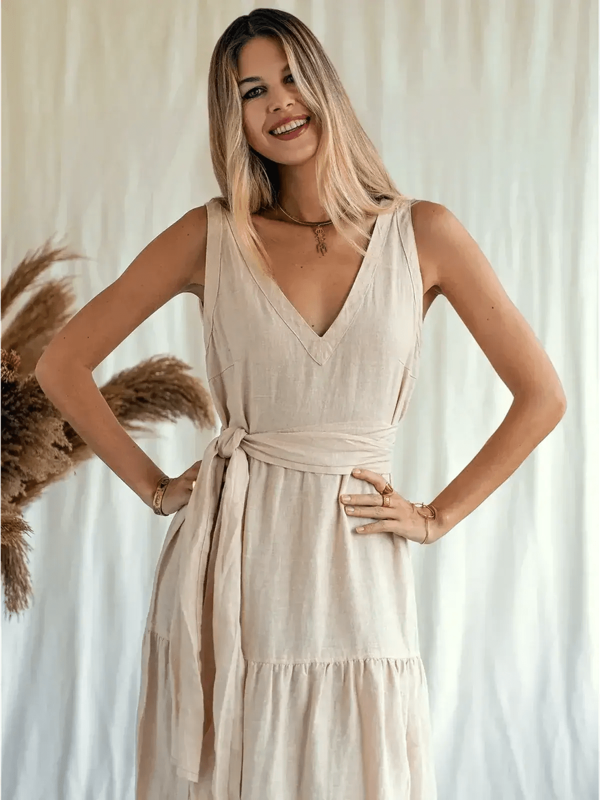 Model showcasing the Sierra Maxi Dress, a sleeveless, linen, V-neck dress with a self-tie belt, perfect for warm days.