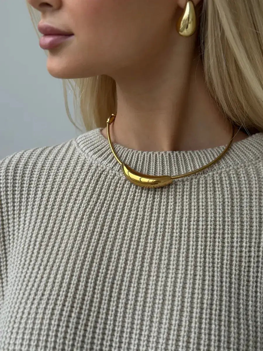 Close-up of a model wearing a Sierra Sweater with gold jewelry, showcasing a cozy, stylish look by Lauven.