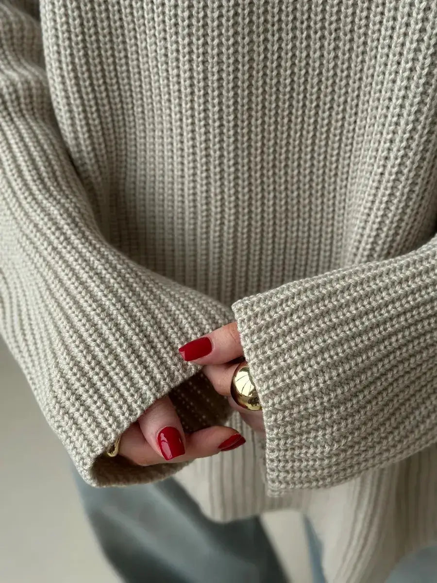 Close-up of hands wearing the Sierra Sweater with oversized beige knit and crew neck, featuring stylish nails.